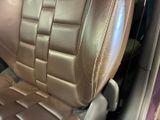 a close up of a car seat with a brown leather cover