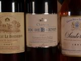 several bottles of wine are lined up on a shelf