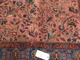 a rug that has a lot of flowers and birds on it