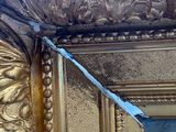 a picture of a gold frame with a mirror in it