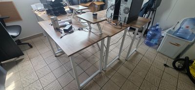 a room with a desk and several computers on it