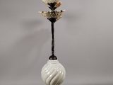 a white vase with a flower on top of it