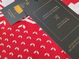 the sweater is red and white with a black tag on it