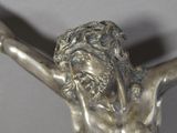 a statue of jesus on the cross with his hands up
