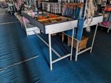 a conveyor belt in the middle of a store filled with items