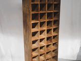an old wooden wine rack with lots of wine bottles on it
