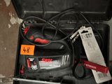 a tool in the case that is sitting on the floor