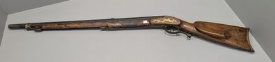 a rifle that is on display on the wall