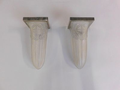 pair of silver plated wall sconces with carved design