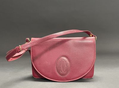 a pink leather purse with a strap and a clasp on it