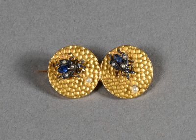 a pair of gold earrings with sapphires and diamonds