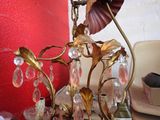 a glass vase with a flower on top of a table