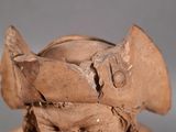 a clay sculpture of a man with a hat on his head
