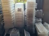 many plastic containers sitting on a table next to a window
