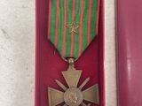 a red box with a medal and a ribbon in it