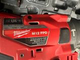 the milwaukee milwaukee m12 fpd corded drill is laying on the floor