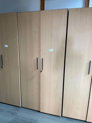 a room with a bunch of cabinets and a cat laying on the floor