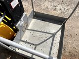 a metal cart with a yellow container on it