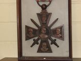 a framed picture of a medal with a cross on it