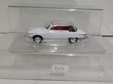 a white car in a clear display case on a table