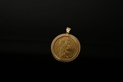 a close up of a gold coin on a black background
