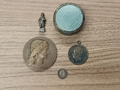 a small coin and a small coin on a wooden table