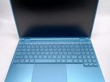 an open laptop computer sitting on top of a white surface