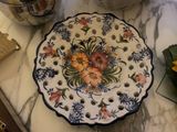 a plate with flowers on it sitting on a counter
