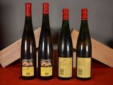 three bottles of wine sitting on a table next to a wooden box