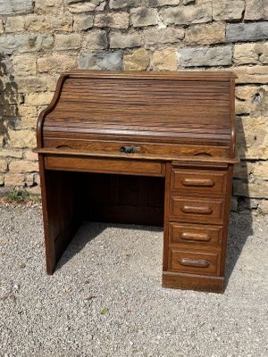 a small wooden cabinet on the side of a stone wall