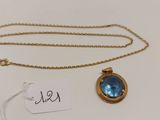 un collier en or orné d'une topaze bleue