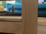 a close up view of a wooden table with a laptop on it