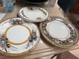 four plates sitting on a table with a water bottle