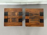 two pieces of wood sitting on top of a table next to each other