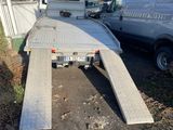 an image of a flatbed trailer parked on the side of the road