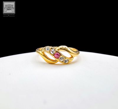 an image of a gold ring with a pink stone in the middle