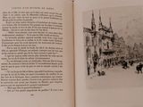 an open book with a picture of a building in the background
