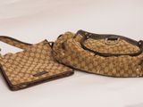 guccissi handbag and purse on a white background