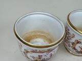 two cups sitting next to each other on a table