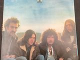 an album with a picture of a group of people sitting on the ground