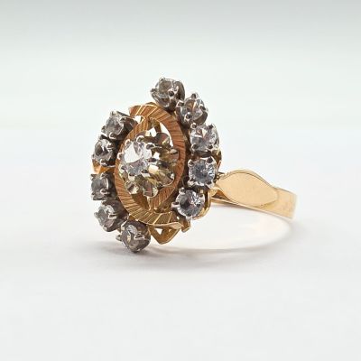 a close up of a gold ring with diamonds on a white background