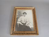 an old picture of a woman sitting in a chair