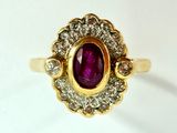 an image of a gold ring with a purple stone surrounded by white diamonds
