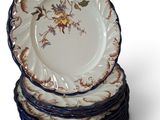 many plates stacked on top of each other on a white surface