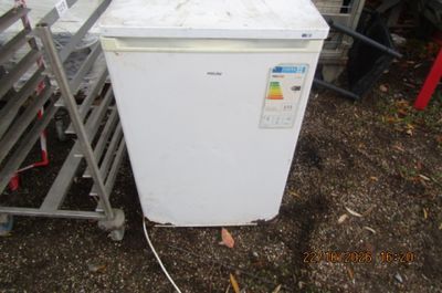 an image of a white refrigerator in a yard