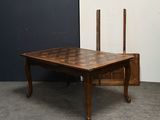 a wooden table with a chess board on it
