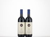 two bottles of red wine sitting on top of a table