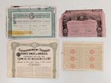 several old papers are on display on a white surface