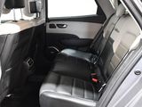 the back seat of a car with a black leather seat cover