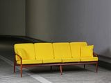 a yellow couch sitting in the middle of a room